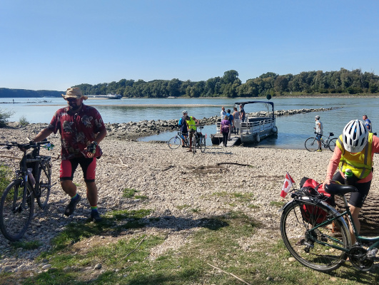 cyclist disembarking from a pontoon boat